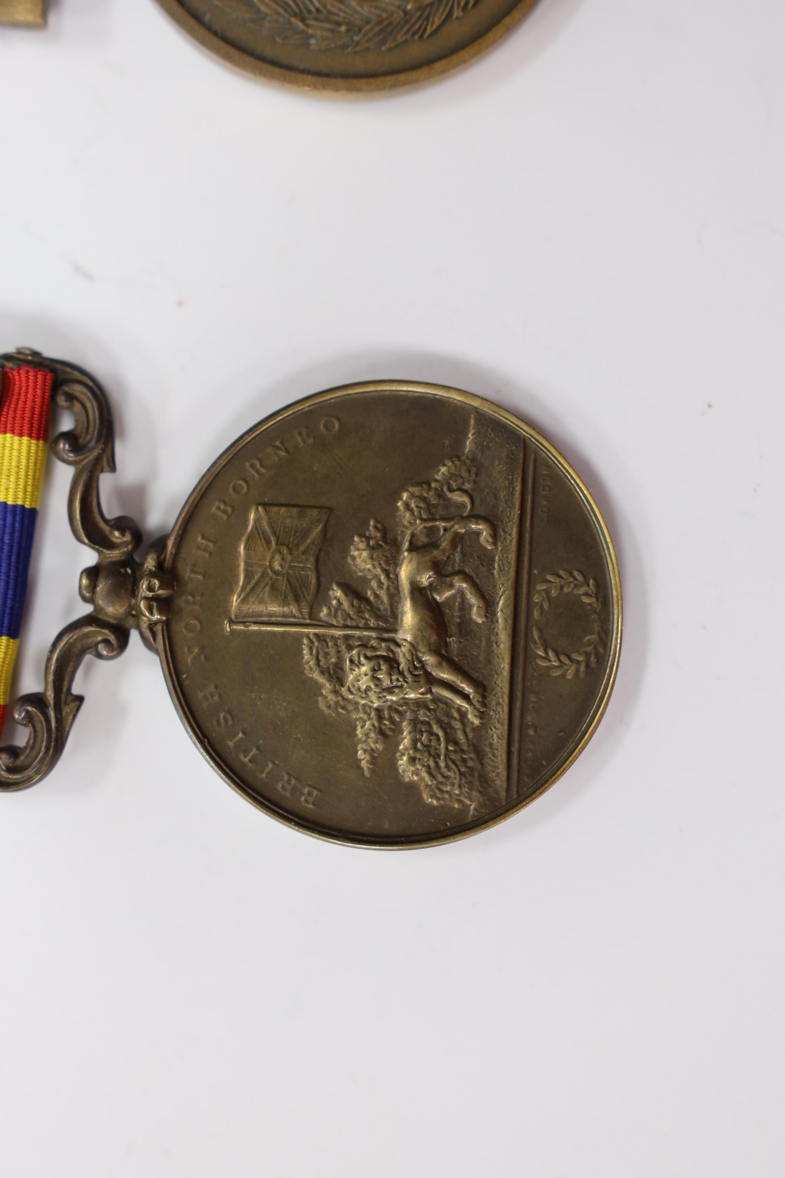 Assorted medals; two replica British North Borneo medals; Balaklava medallion; bronze GV medal; German China Campaign medal; bronze NRA medallion, unnamed